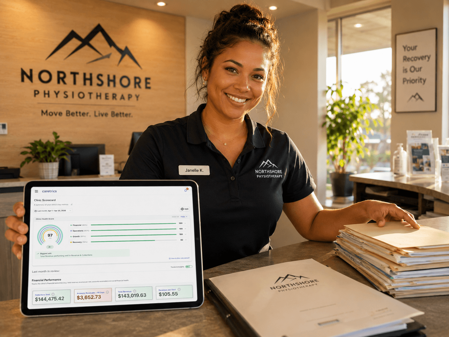 A clinic front-desk team member at the monitor, signed in to Jane.app with the Caretrics Staff profile.